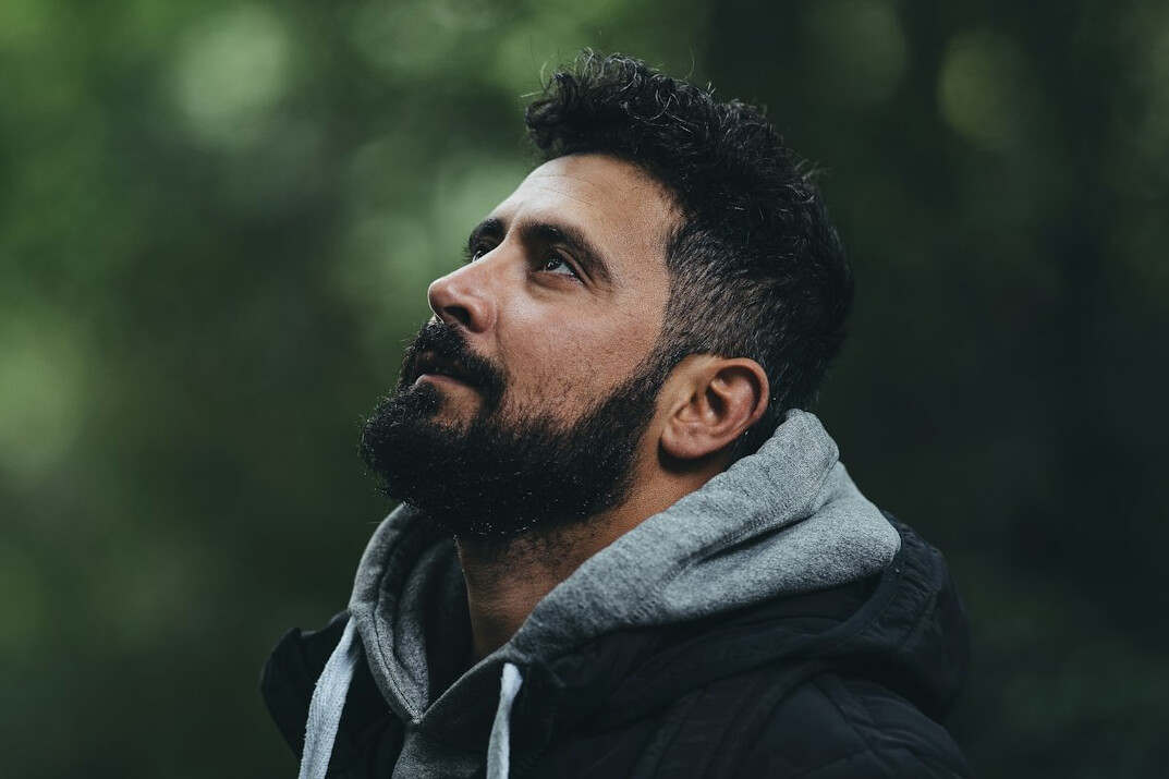 Portrait of a man with dark hair and beard